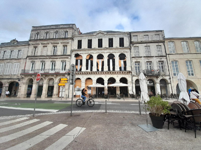 Most of the windows of the building in the middle are boarded up at the moment.