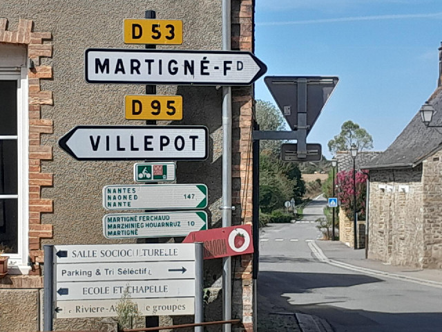 The middle language on the cycle route signs is Breton. My guess is that the bottom one is probably ...