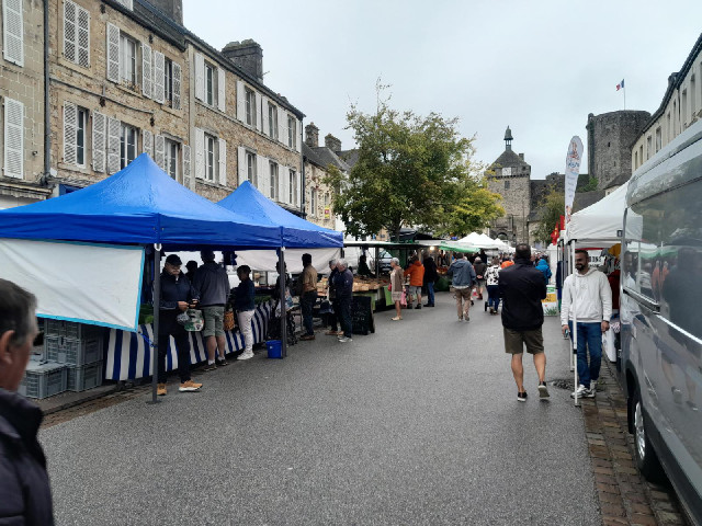 The stall on the left sells shellfish. The blackboard is advertising mussels from Utah Beach.