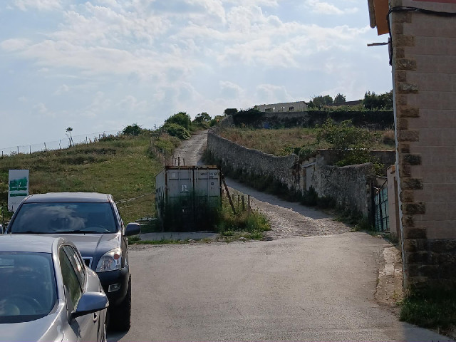 The route recommended by Google Maps goes that way, along the pilgrim route. Roughly where the path ...