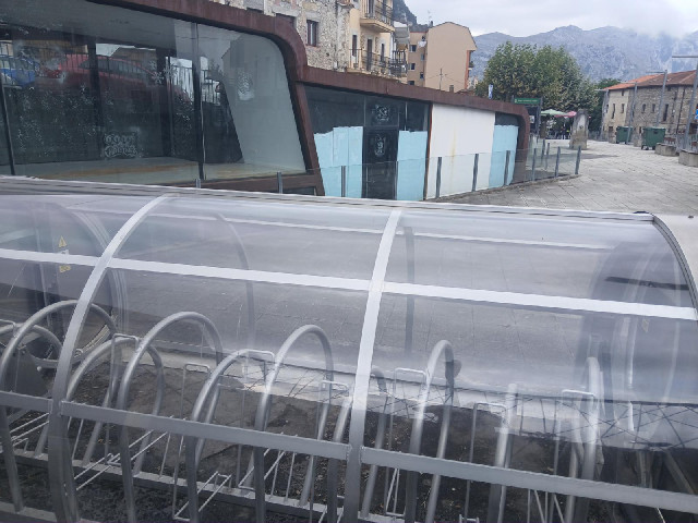 The signs imply that you need some  kind of remote control to open this bike rack in Islares. This s...