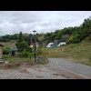 Portals of a motorway tunnel, seen from a bench where I am having a rest on the way up a very steep ...