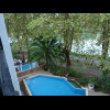 Tonight, my view is of the pool, part of the terrace of the restaurant, which closes at half past ni...
