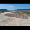 At the North end of that unpaved section, a huge hole has been filled with whole bricks and smashed ...
